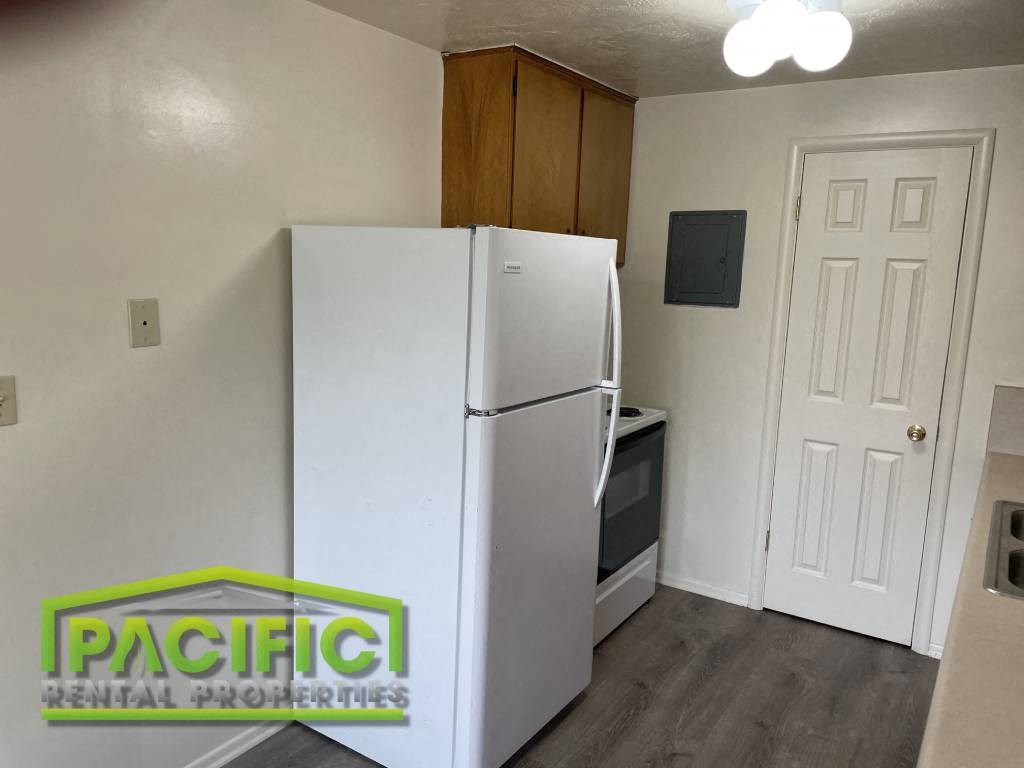 a kitchen with a refrigerator and a door