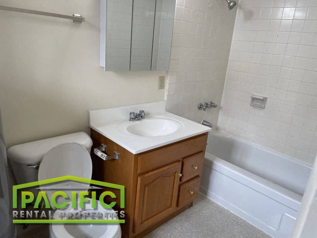 a small bathroom with a toilet sink and tub