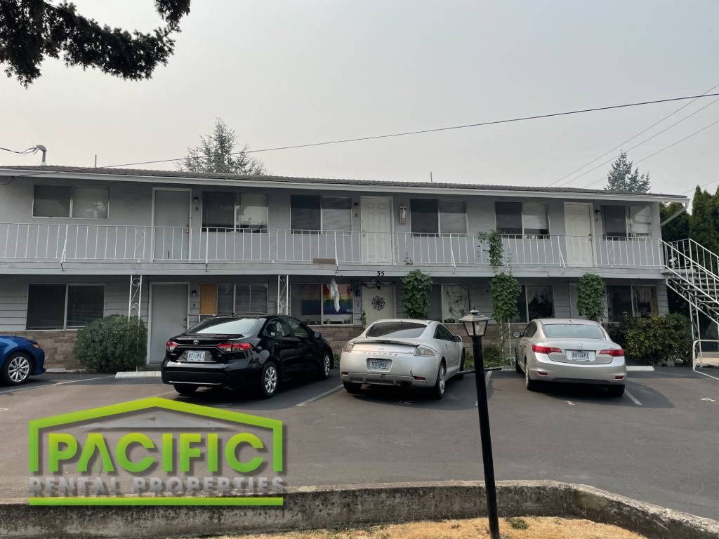 an office building with cars parked in front of it