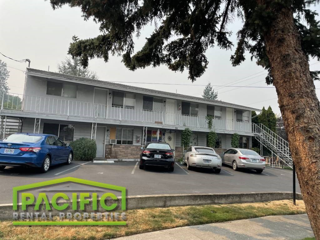 a parking lot with cars in front of a building
