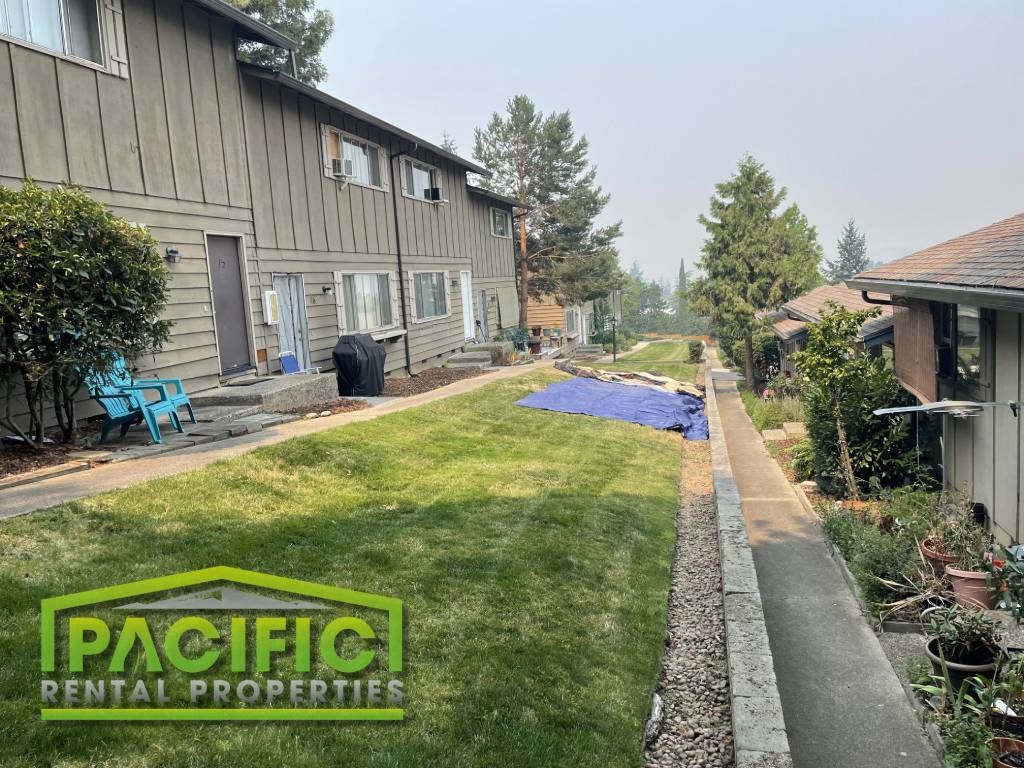 a backyard with a blue tarp on the grass