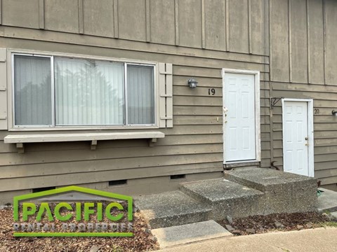 the front of a house with a porch and a door