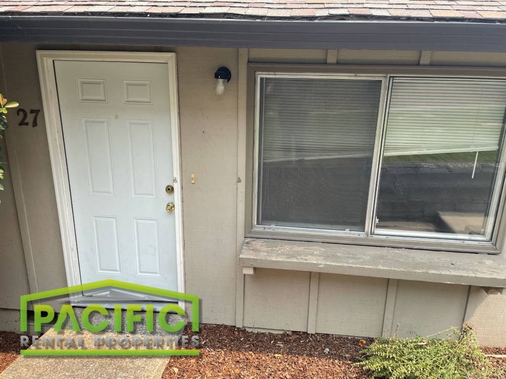 a small house with a window and a white door