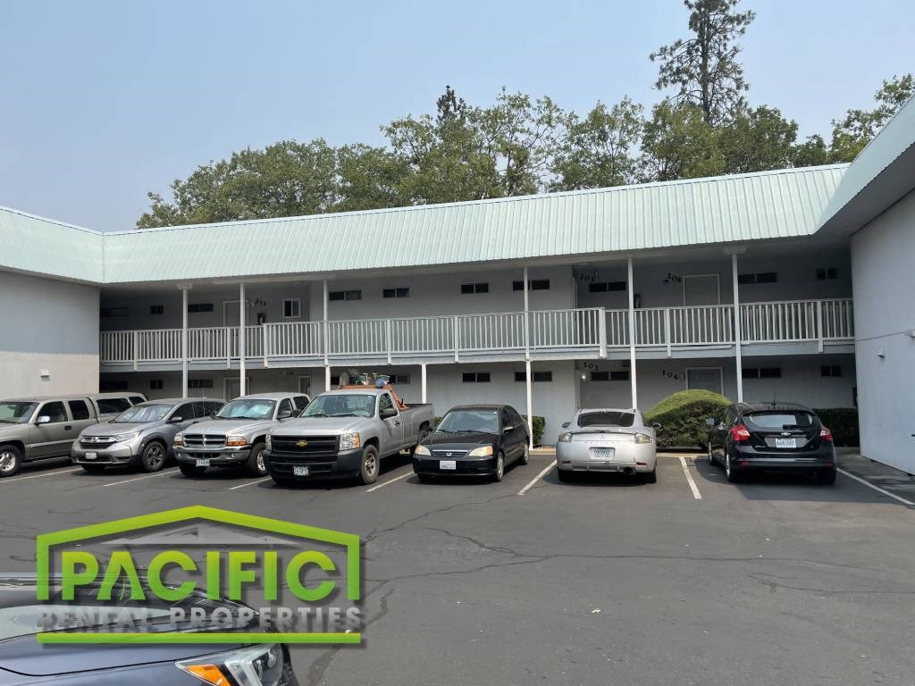 a parking lot with cars in front of a building