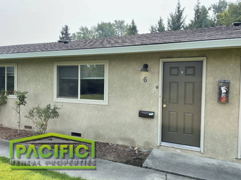the front of a house with a brown door