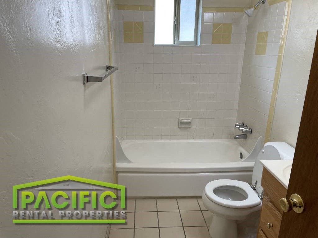 a bathroom with a toilet and a bath tub