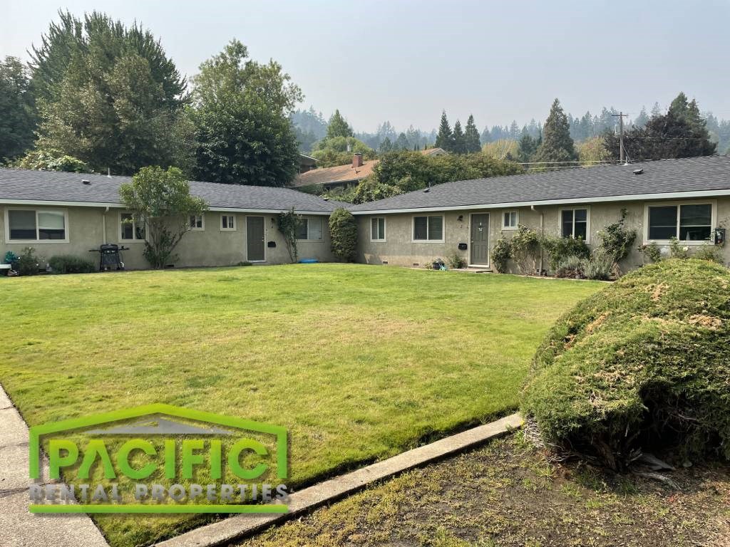 a yard in front of a house with a lawn