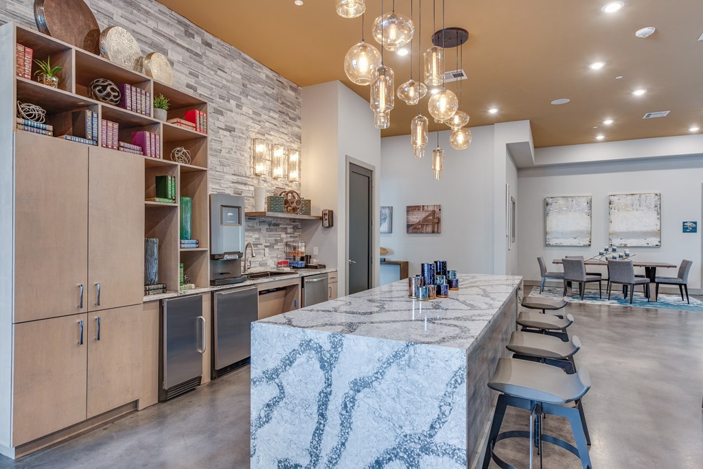 a kitchen with a long island and chairs in front of a dining table