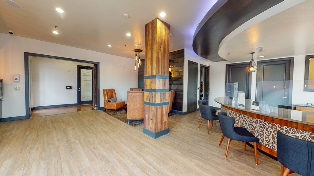 a lobby with a table and chairs and a pillar