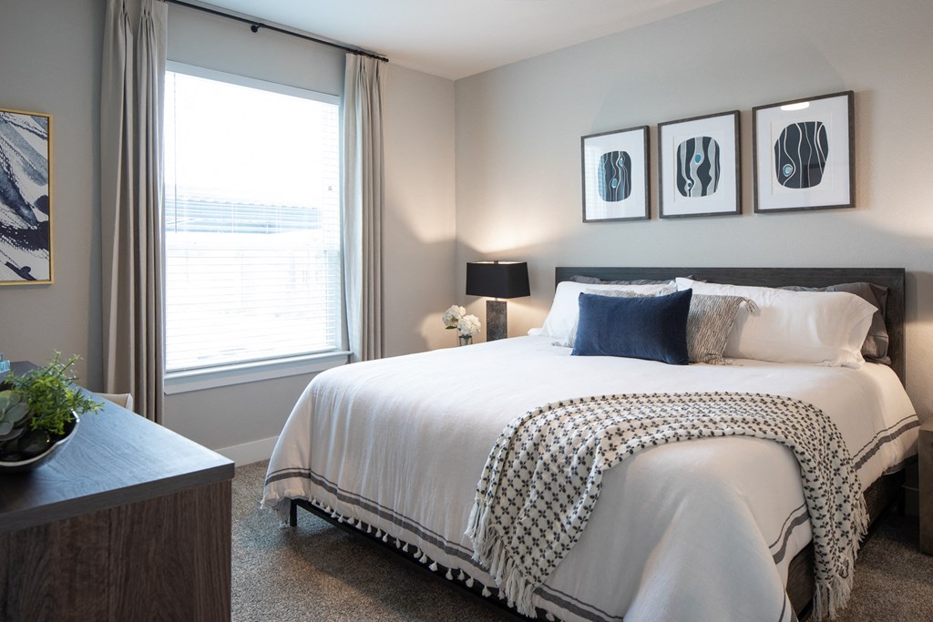 a bedroom with a large bed and a window