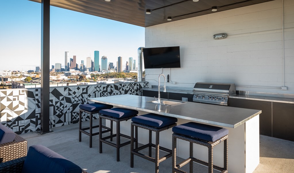 a kitchen with a bar and a view of the city