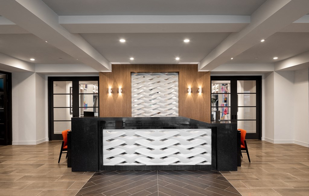a lobby with a reception desk and chairs