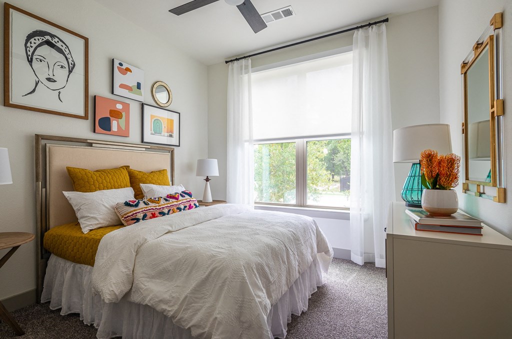 a bedroom with a bed and a large window