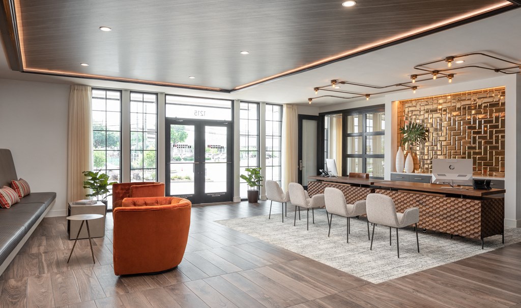 the lobby of a hotel with a reception desk and chairs