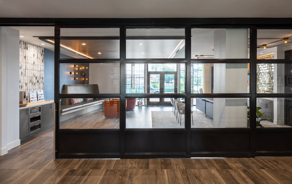 a kitchen and living room seen through a large glass door