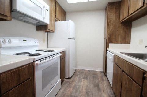 a kitchen with a stove and a refrigerator