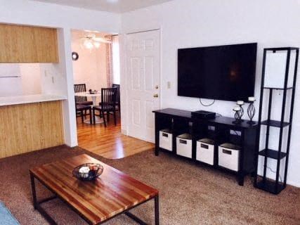 a living room with a coffee table and a television
