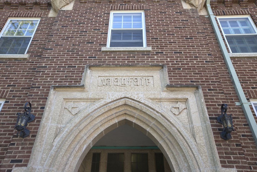 A building with a brick facade and a large arched entrance.