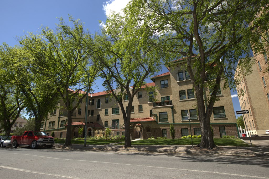 A red truck is parked on the side of a street.