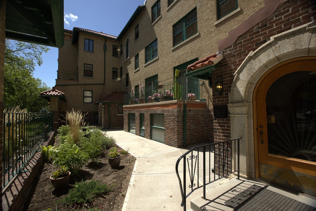 A building with a brick facade and a metal railing.