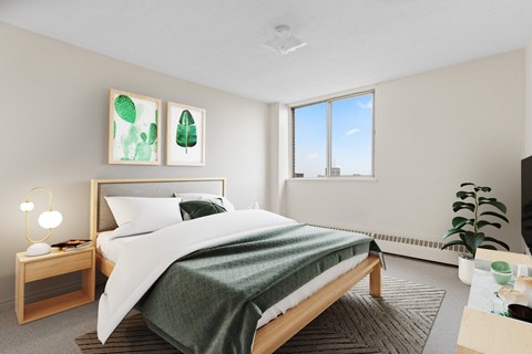A bedroom with a large bed and a window overlooking a cityscape.