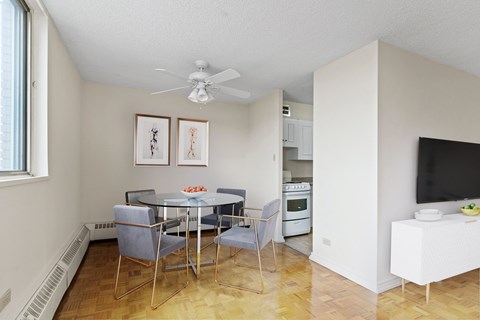 A dining room with a glass table and chairs.