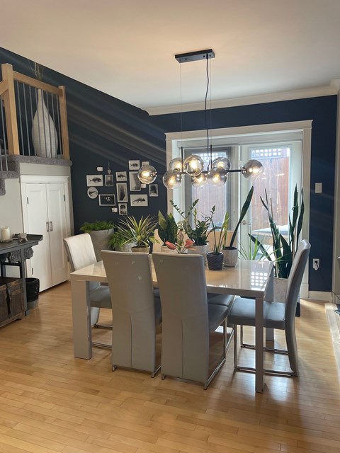 A dining room with a table and chairs.