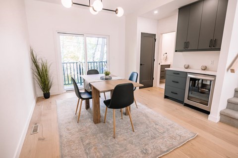 A dining room with a table and chairs.