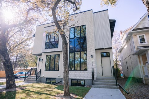 A modern house with a white exterior and large windows.
