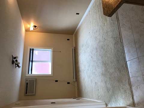 a bathroom with a tub and a window