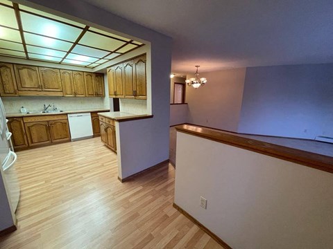 A kitchen with wooden cabinets and a counter top.