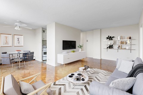 A living room with a grey couch and a white coffee table.