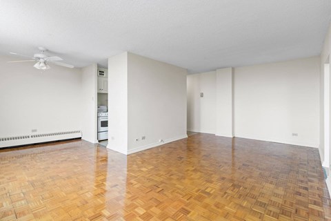 A room with a wooden floor and a ceiling fan.