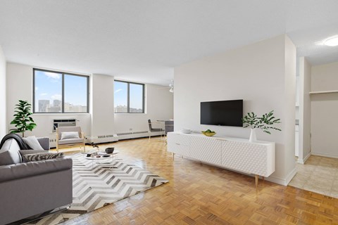 A living room with a grey couch and a white sofa.