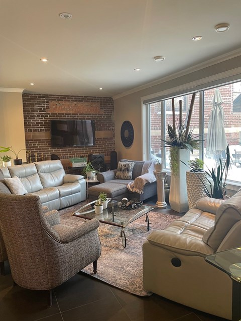 A living room with a brown chair and a white couch.