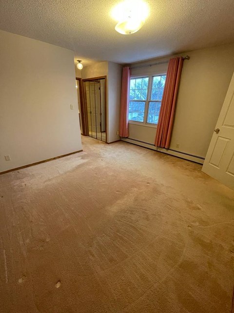 A room with a window and a door.