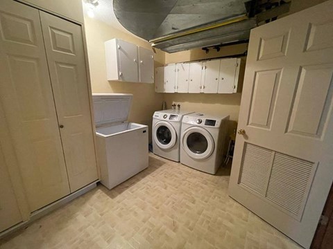 A small laundry room with a washer and dryer.