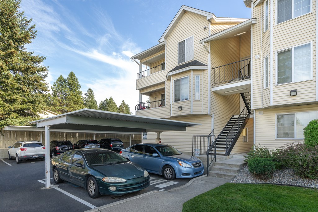 an apartment building with cars parked in front of it