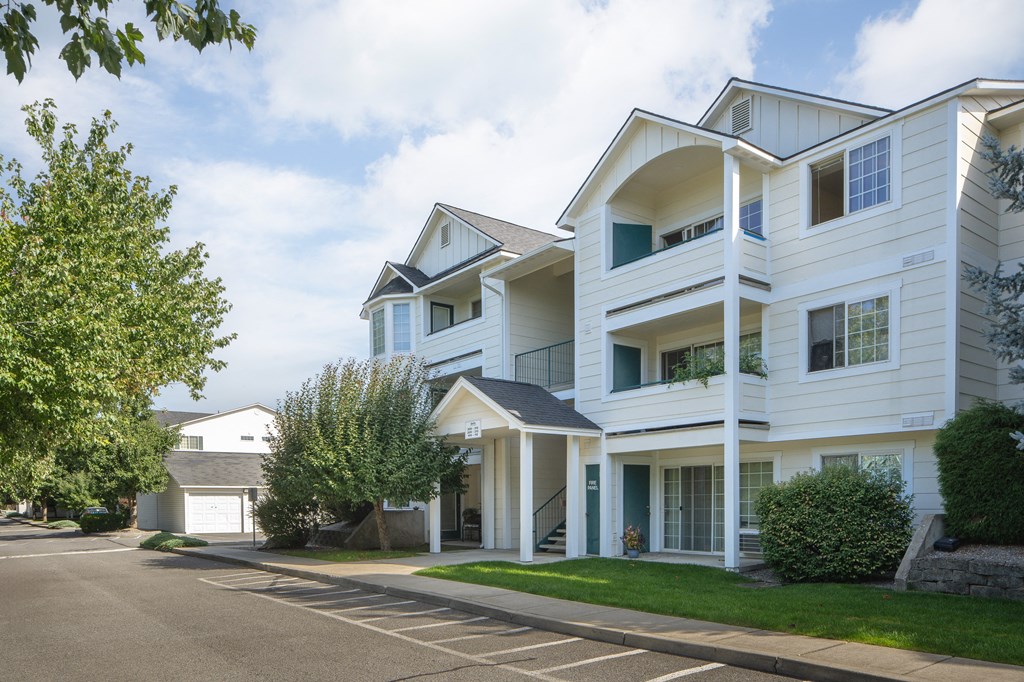 a large white house with a street in front of it
