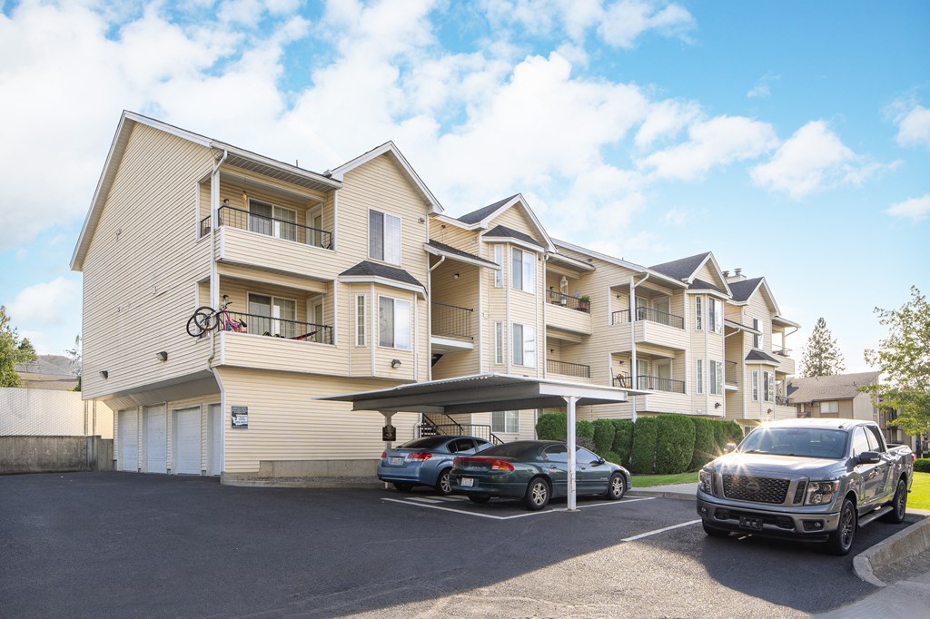 two cars parked in front of an apartment building