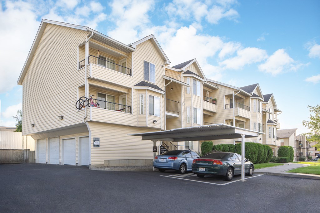 two cars parked in front of an apartment building