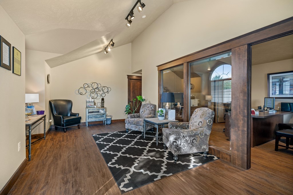 a living room with a couch and chairs and sliding glass doors