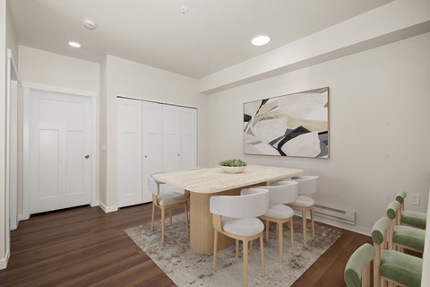 A dining room with a table and chairs.