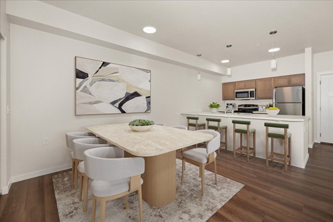 A modern dining room with a large table and chairs.