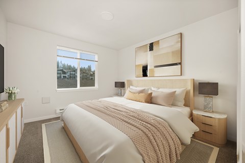 A bedroom with a large bed and a window overlooking a residential area.