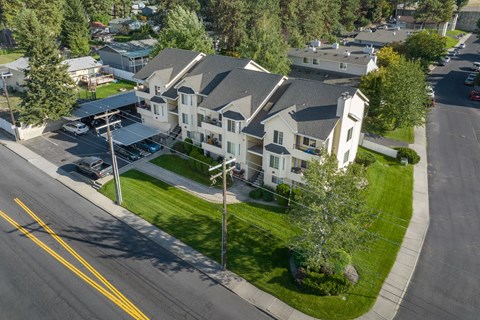 an aerial view of a large white house on a city street