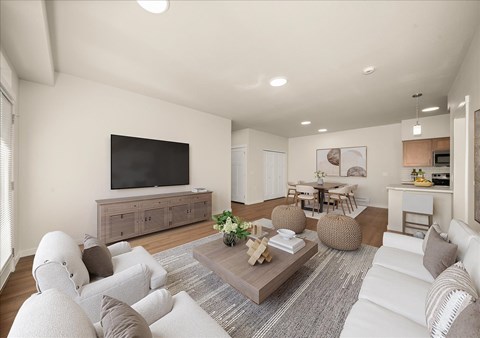 A living room with a white couch and a wooden coffee table.
