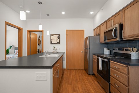 a kitchen with stainless steel appliances and black counter tops