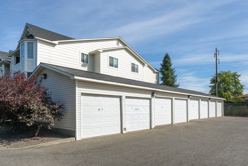 a white garage with a row of white doors