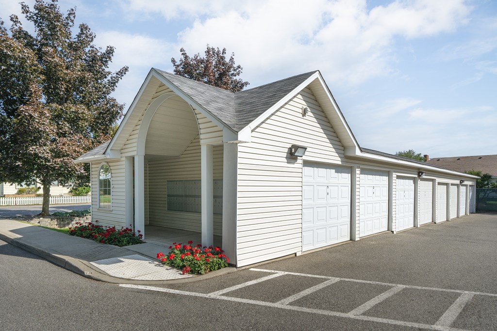 a white garage with a row of white garage doors